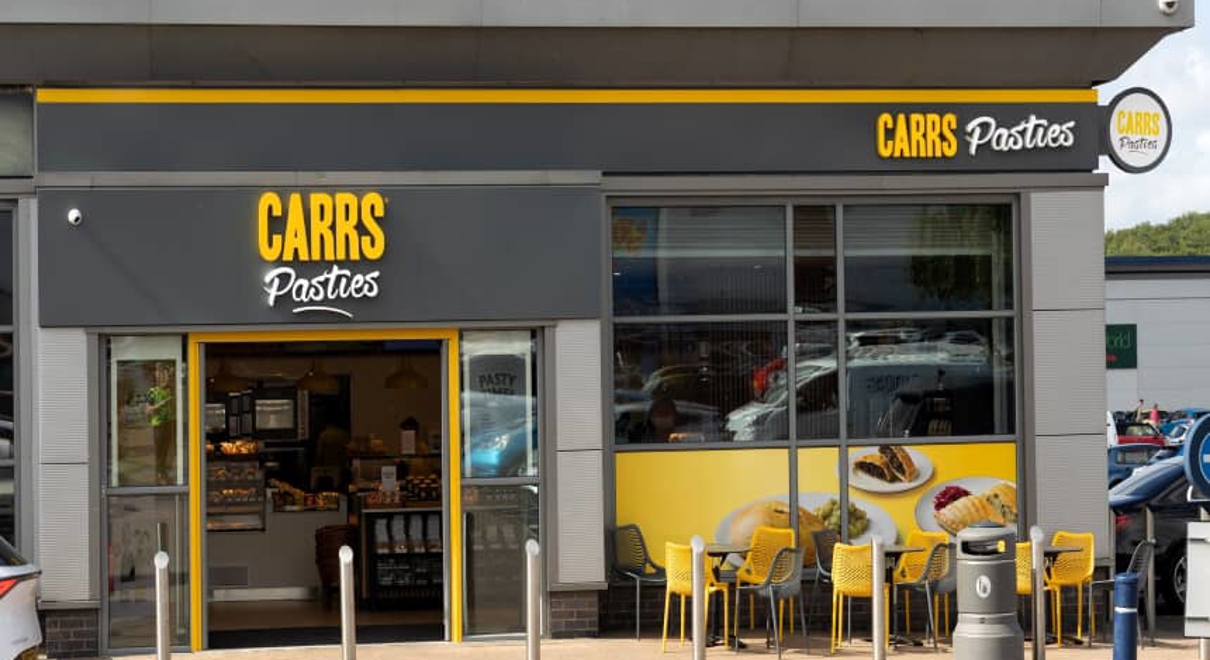 exterior signage of Carrs Pasties in grey and yellow